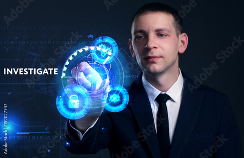 Business, Technology, Internet and network concept. Young businessman working on a virtual screen of the future and sees the inscription: Investigate