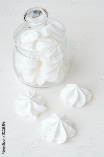 White fresh meringues in a glass jar 