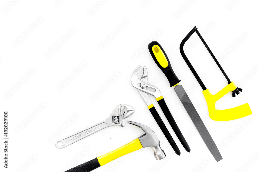 Tools for repair and building. File, saw, hummer on white background top view copy space