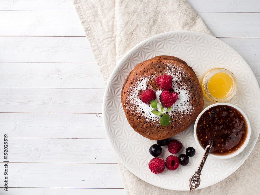 Chocolate pancakes with powdered sugar raspberry. Copy space Chocolate pancakes with powdered sugar raspberry. Copy space
