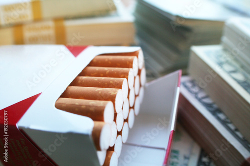 Tobacco Profits With Stacks Of Money Surrounding Cigarettes 