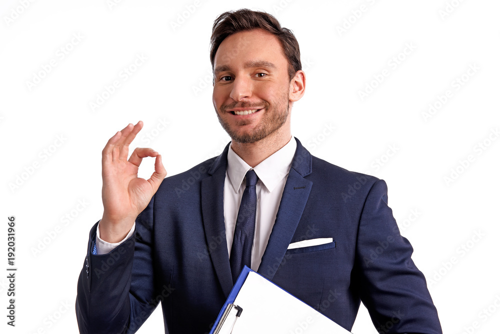 Handsome bearded businessman in office suit and tie isolated on white background. Professional bank manager is holding a blank clipboard Handsome bearded businessman in office suit and tie isolated on white background. Professional bank manager is holding a blank clipboard