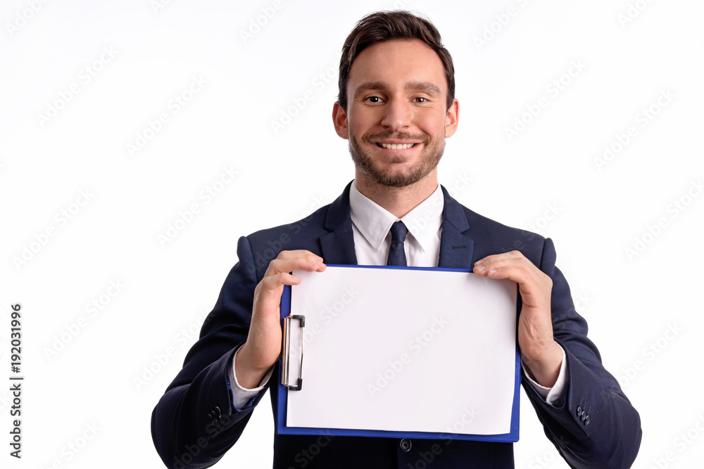 Handsome bearded businessman in office suit and tie isolated on white background. Professional bank manager is holding a blank clipboard Handsome bearded businessman in office suit and tie isolated on white background. Professional bank manager is holding a blank clipboard