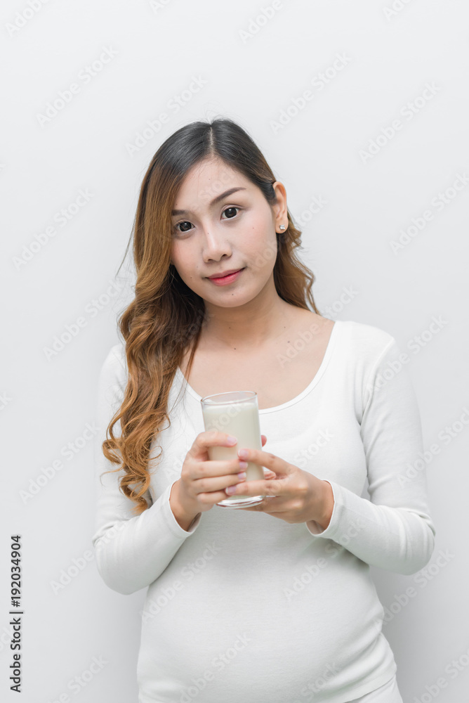 Pregnant woman with milk in her hand,Drinking milk is good health to the pregnancy Pregnant woman with milk in her hand,Drinking milk is good health to the pregnancy