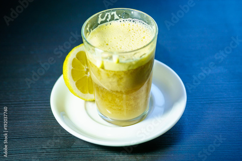 A glass of traditional drink for stamina or energy drink with eggs and tea. Teh talua or teh telor is a tea beverage from West Sumatra. The tea is unique because of the use of egg yolk. photo