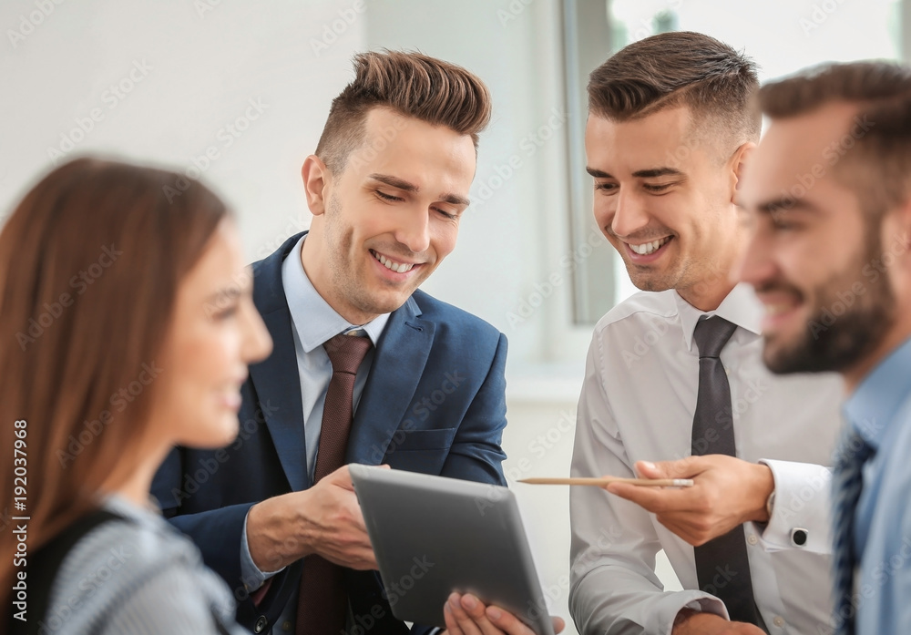 Team of specialists engaged in work on business project Team of specialists engaged in work on business project