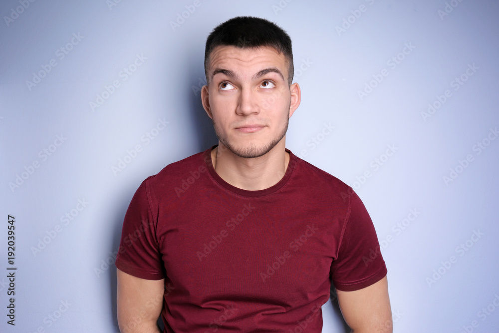 Emotional young man with dyed eyebrows on light background Emotional young man with dyed eyebrows on light background