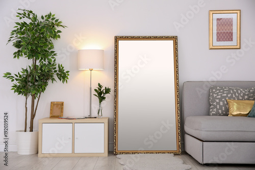 Elegant room interior with large mirror photo