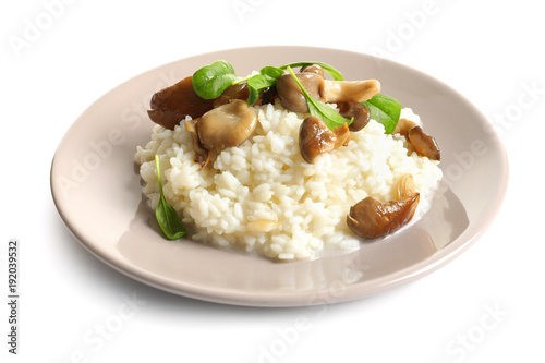 Plate with risotto and mushrooms on white background