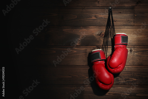 Boxing gloves on wooden background © Africa Studio