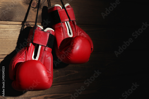 Boxing gloves on wooden background © Africa Studio