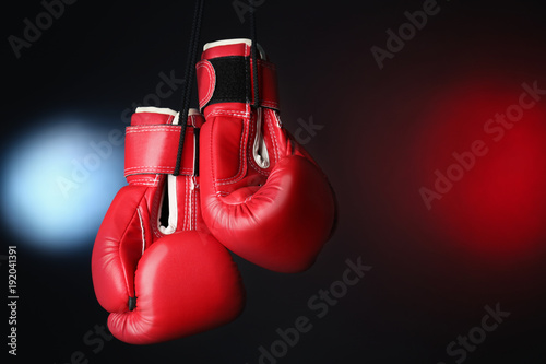 Boxing gloves on dark background © Africa Studio