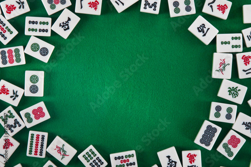 White-green tiles for mahjong on on green cloth background