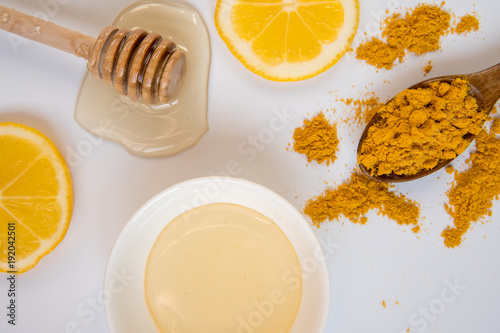 Honey stick, spoon with turmeric and lemon slices