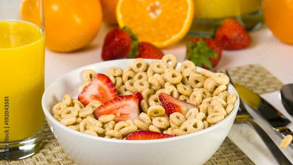 Breakfast cereal being poured into a bowl in slow motion. Breakfast cereal being poured into a bowl in slow motion.