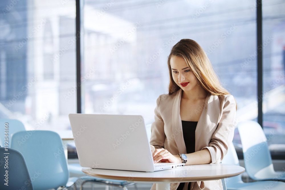 Businesswoman in the office sitting and working with laptop