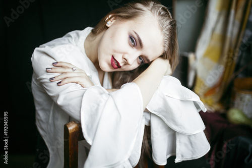 Portrait of smiling Caucasian woman leaning on chair photo