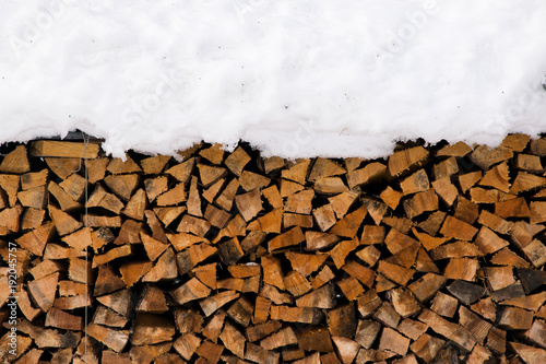 Firewood for the wintertime, when it is cold outside.