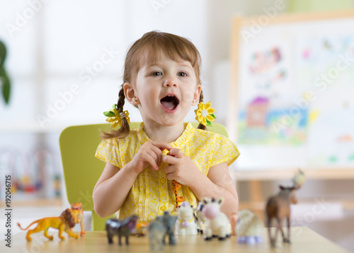 Happy little toddler plays ...