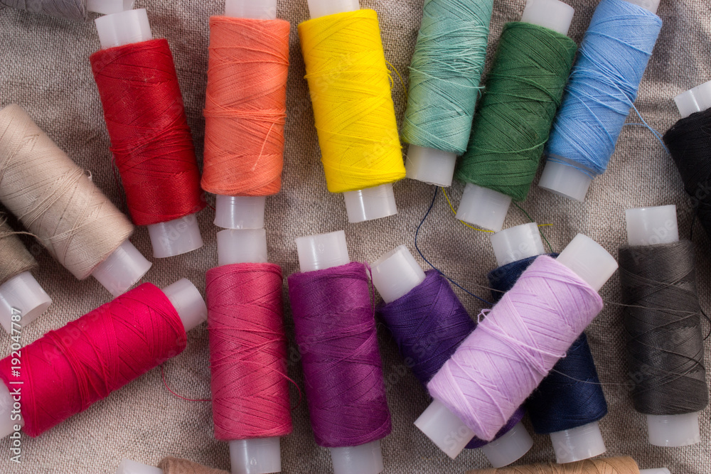 Colored thread on a linen background Colored thread on a linen background