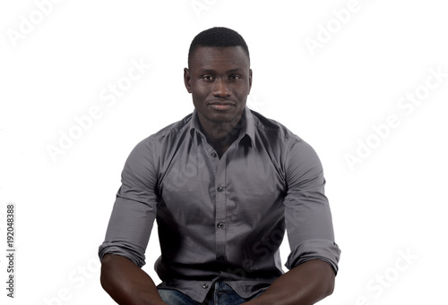 portrait of a african man sitting on white