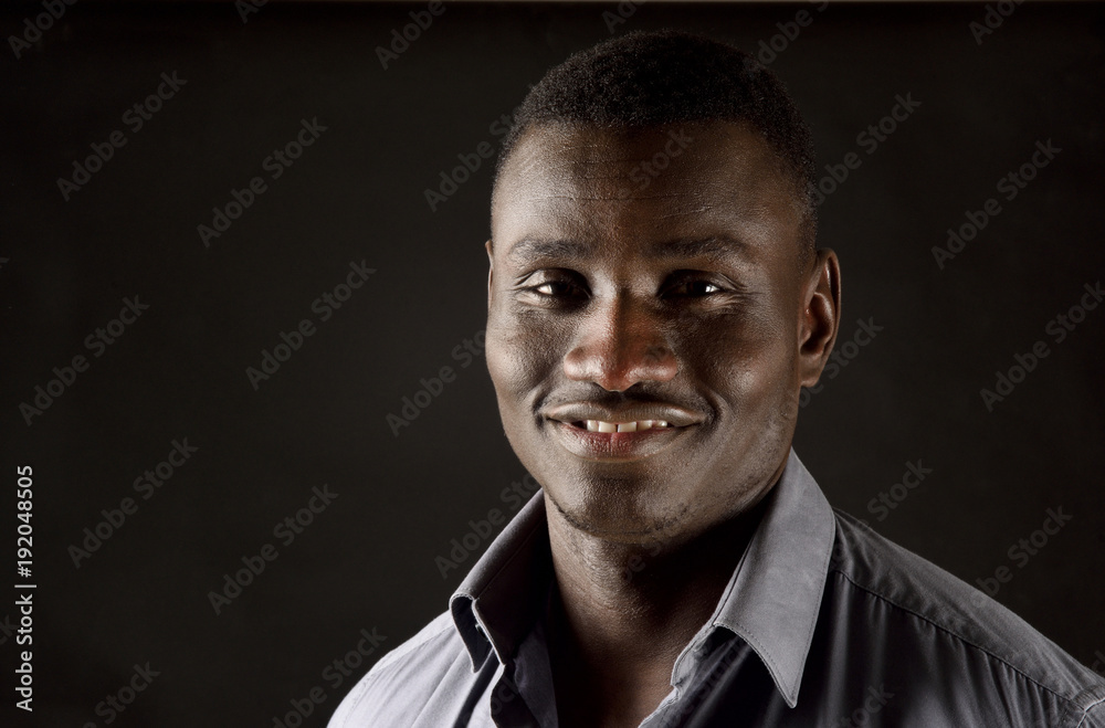 Fototapeta premium portrait of a african man on black