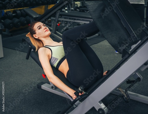 Young girl makes exercises at the gym