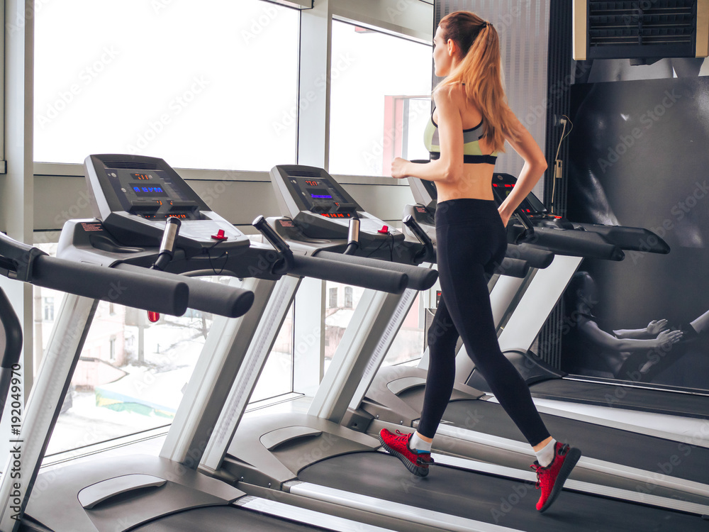 Young girl makes exercises at the gym
