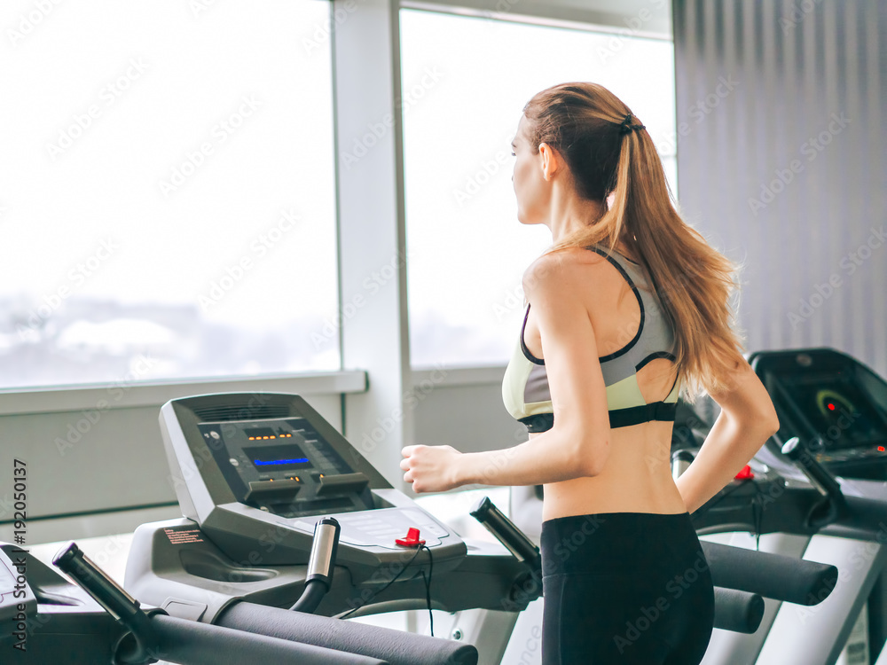 Young girl makes exercises at the gym Young girl makes exercises at the gym