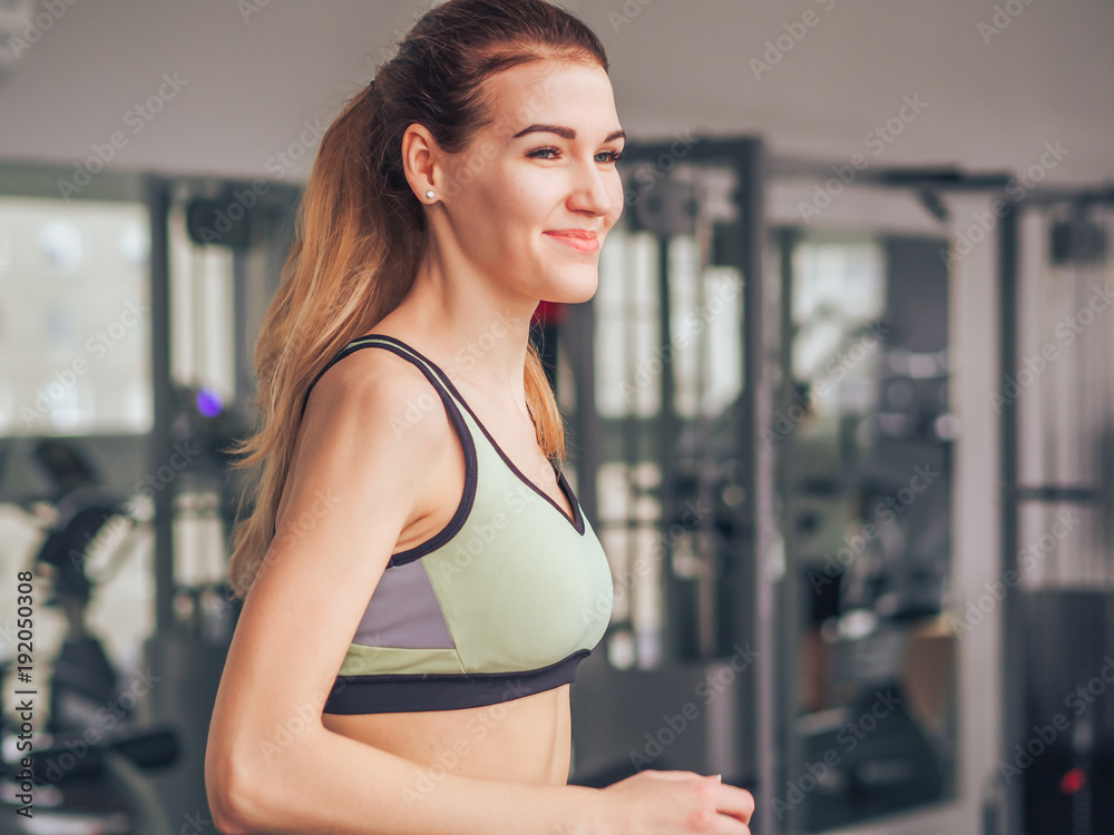 Young girl makes exercises at the gym