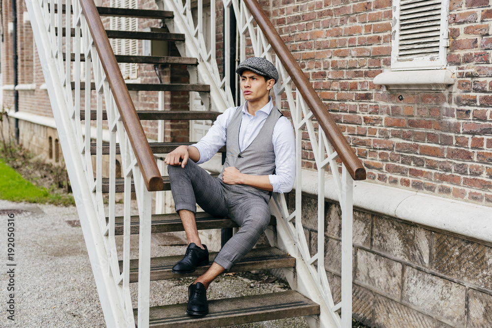 Cheerful man in cap on stairs Cheerful man in cap on stairs