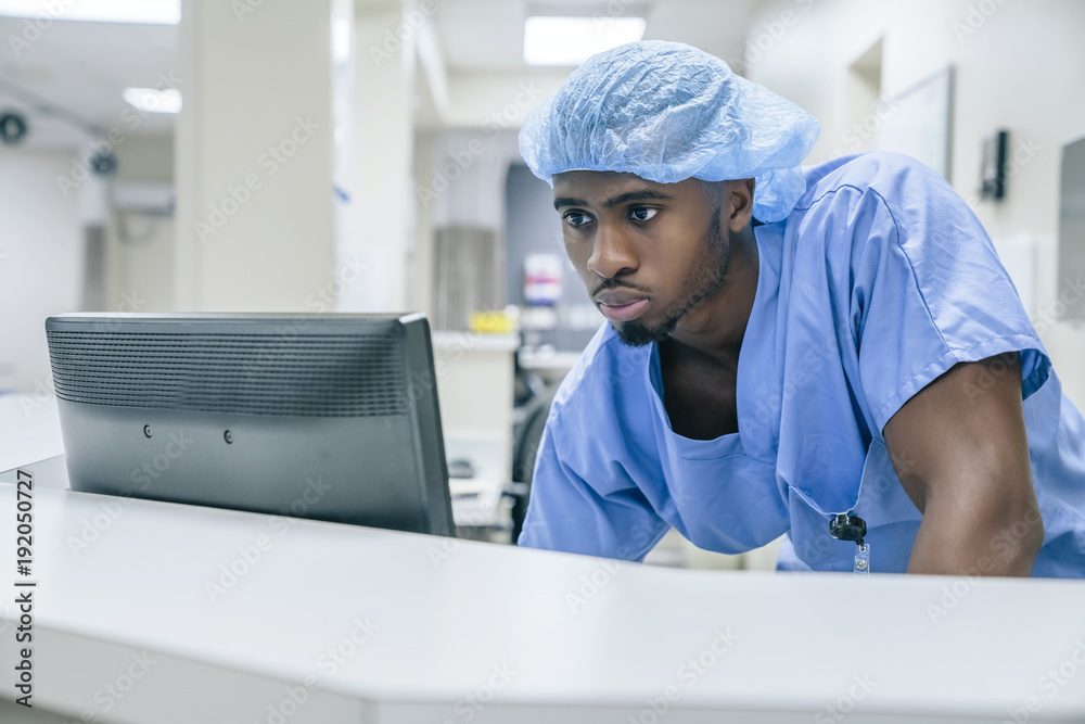 Black doctor using computer in hospital Black doctor using computer in hospital