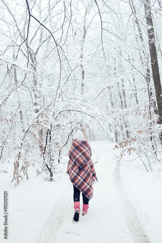 a girl in a plaid in a cage in winter