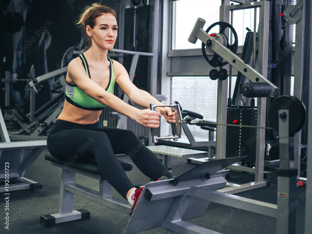 Young girl makes exercises at the gym Young girl makes exercises at the gym