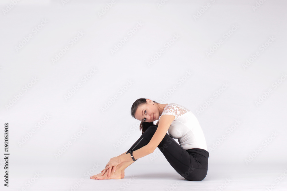 attractive, happy woman resting after training pilates: a healthy body, a feminine smile, a harmony in the soul attractive, happy woman resting after training pilates: a healthy body, a feminine smile, a harmony in the soul