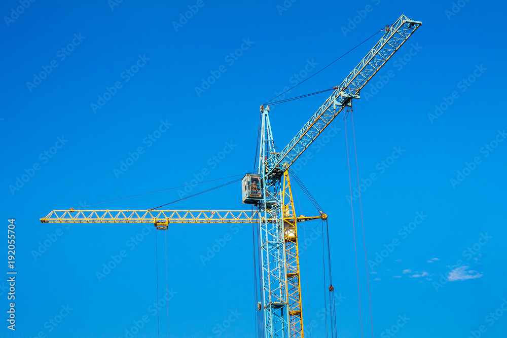 Two cranes against the blue sky. Two cranes against the blue sky.