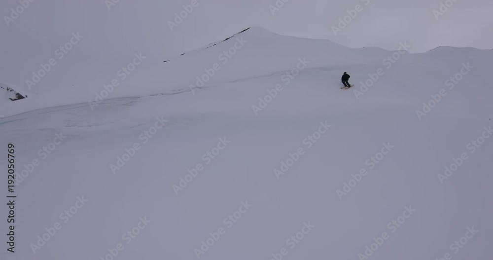 Skier hand drags on snow mountain, pan left Skier hand drags on snow mountain, pan left