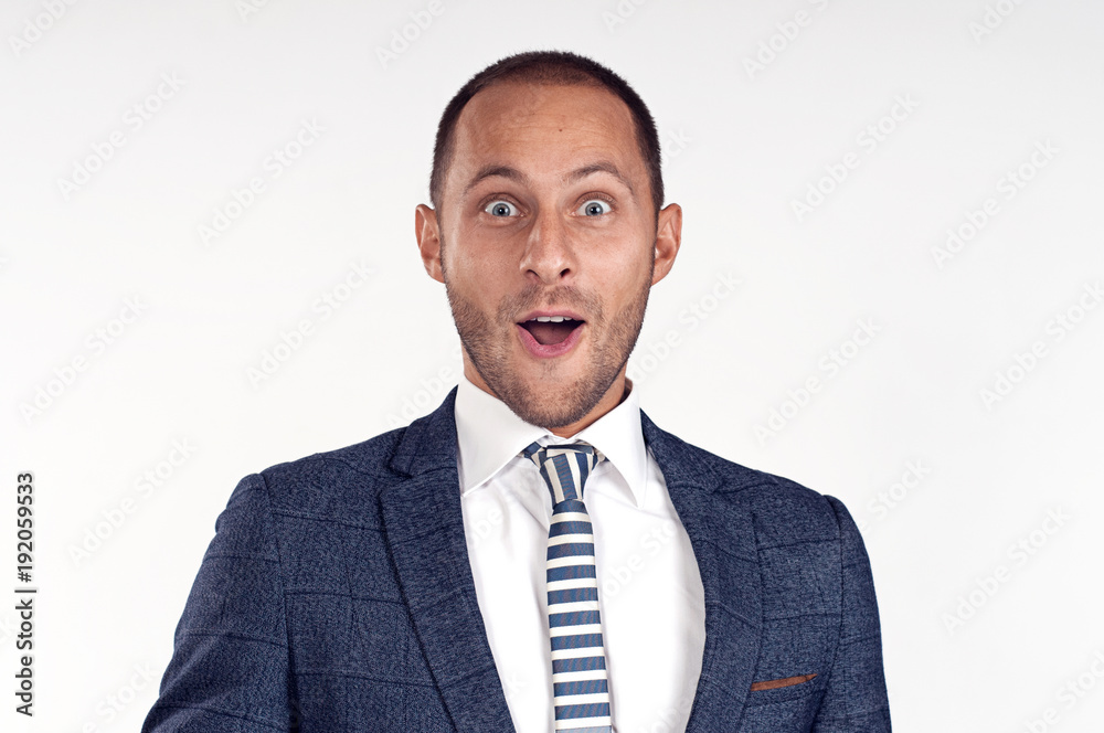A cheerful man in a suit with a tie is surprised.
White background. Isolated image.
Portrait of a surprised young man smiling. A cheerful man in a suit with a tie is surprised.
White background. Isolated image.
Portrait of a surprised young man smiling.