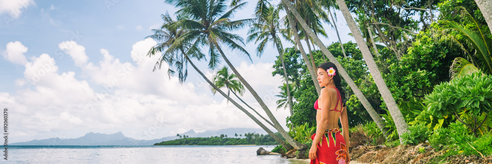 Tahiti luxury exotic travel vacation girl with polynesian flower walking on beach landscape with palm trees. Asian woman in red bikini and beachwear banner panorama. - obrazy, fototapety, plakaty 