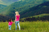Beautiful mother and daughter on the mountain