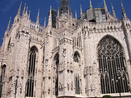 Beautiful windows and white marble architecture of the cathedral in Milan