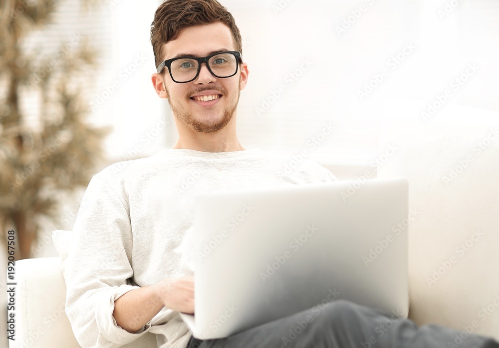 successful young male freelancer working on laptop at home. successful young male freelancer working on laptop at home.