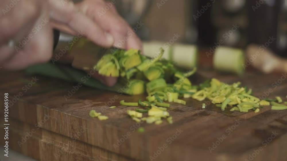 Man cuts leeks into small pieces of video