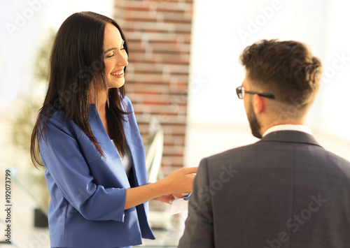 Smiling businesswoman communicating with male colleague