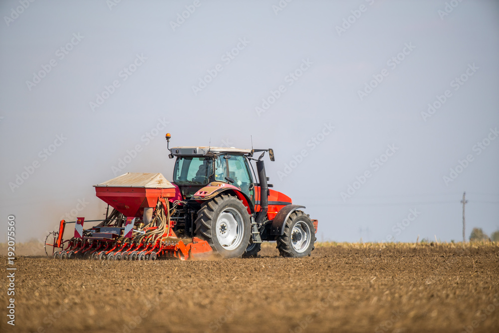 Farmer seeding, sowing crops at field. Sowing is the process of planting seeds in the ground as part of the early spring time agricultural activities. Farmer seeding, sowing crops at field. Sowing is the process of planting seeds in the ground as part of the early spring time agricultural activities.