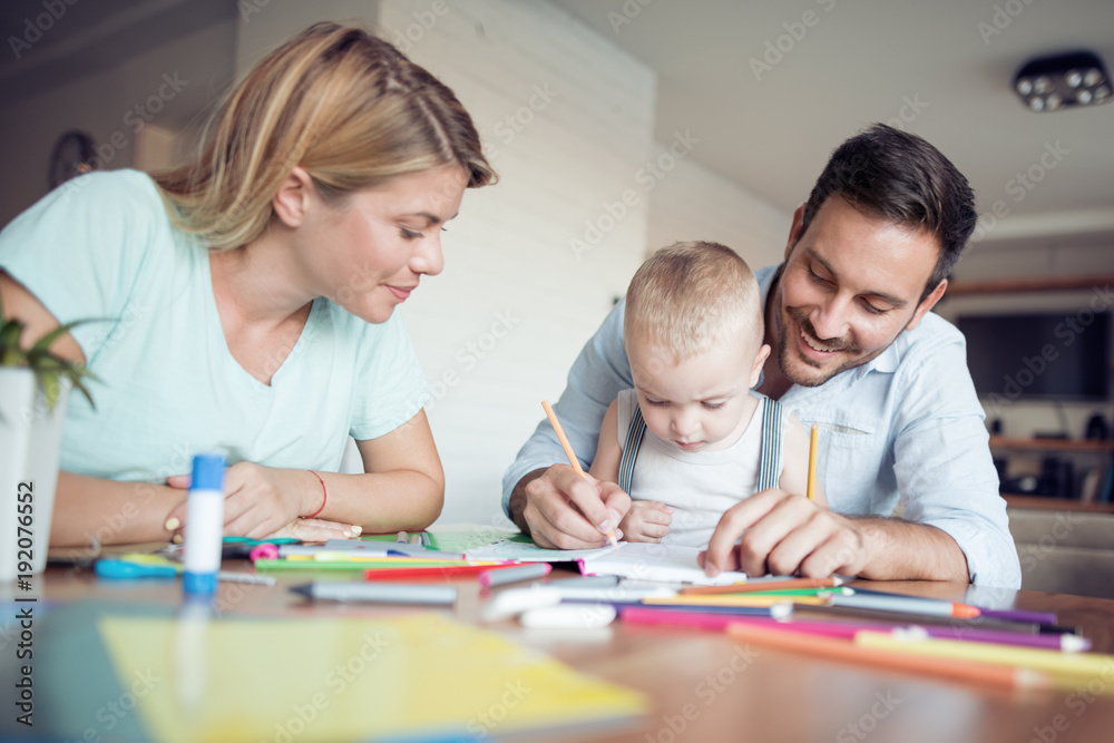 Mom, dad and son draw in the living room. Mom, dad and son draw in the living room.
