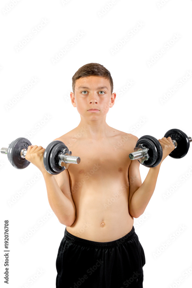Teenage boy exercising with dumbbells Teenage boy exercising with dumbbells