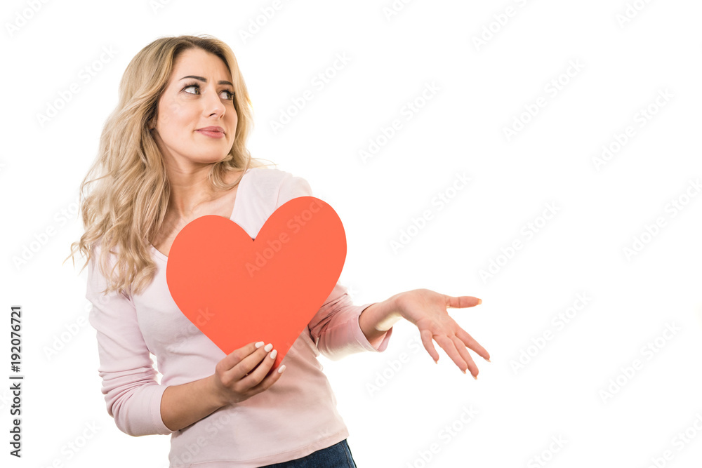The beautiful woman holding a heart sign on the white background The beautiful woman holding a heart sign on the white background