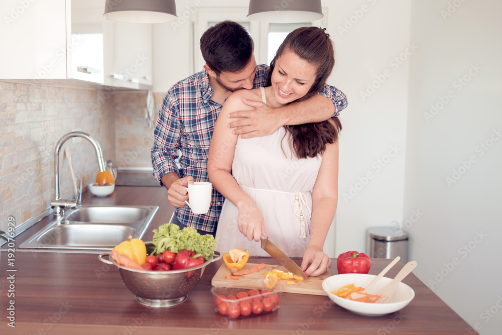 Young couple having fun from preparing food together.