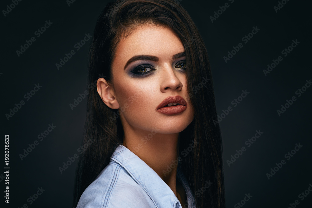 Beauty portrait of a young black-haired woman in the studio Beauty portrait of a young black-haired woman in the studio